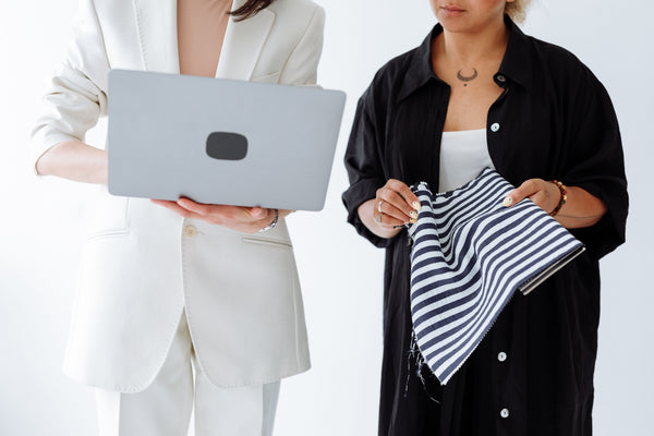 Two professionals reviewing fabric and specifications